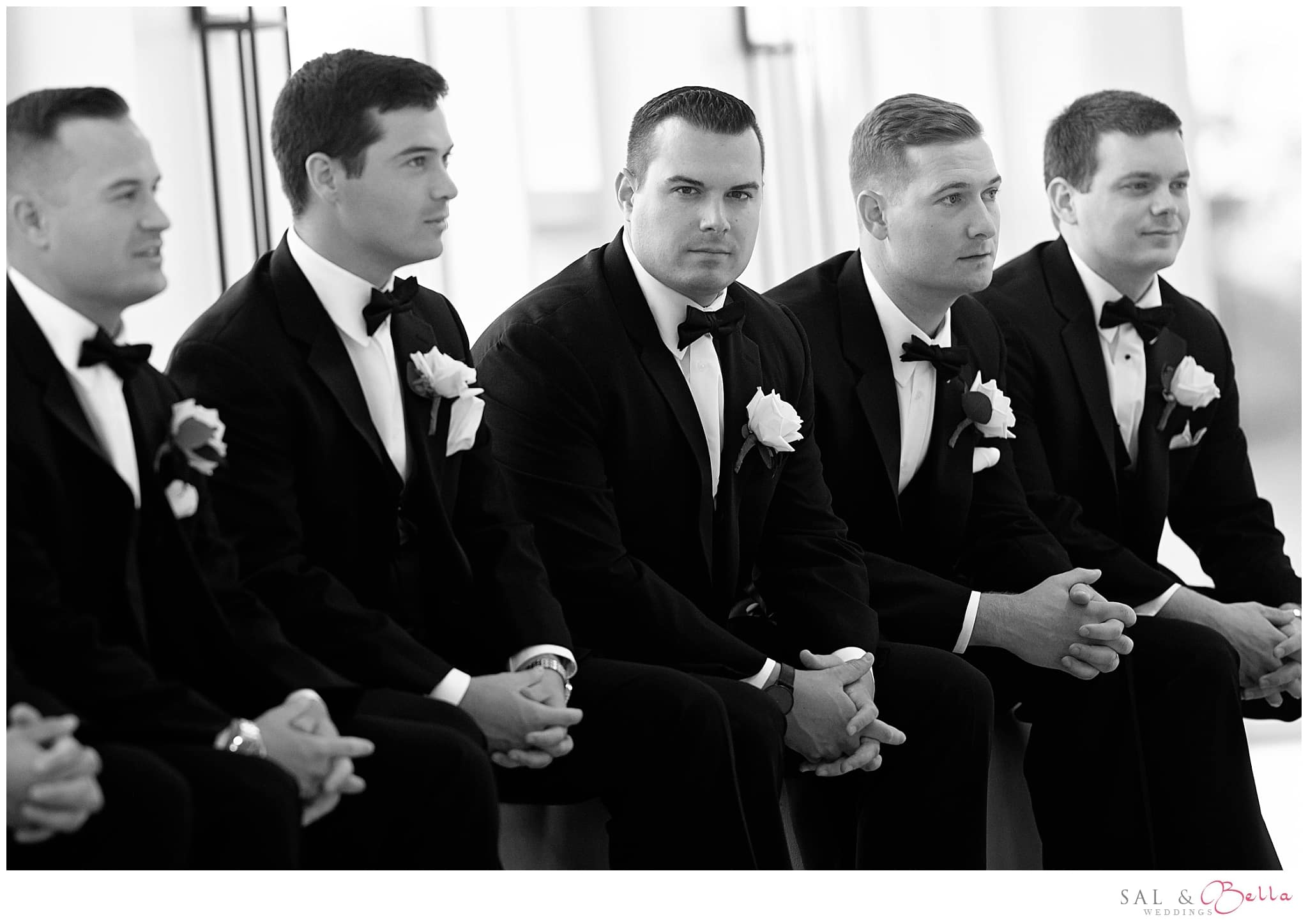 Groomsmen sitting for a wedding photo.