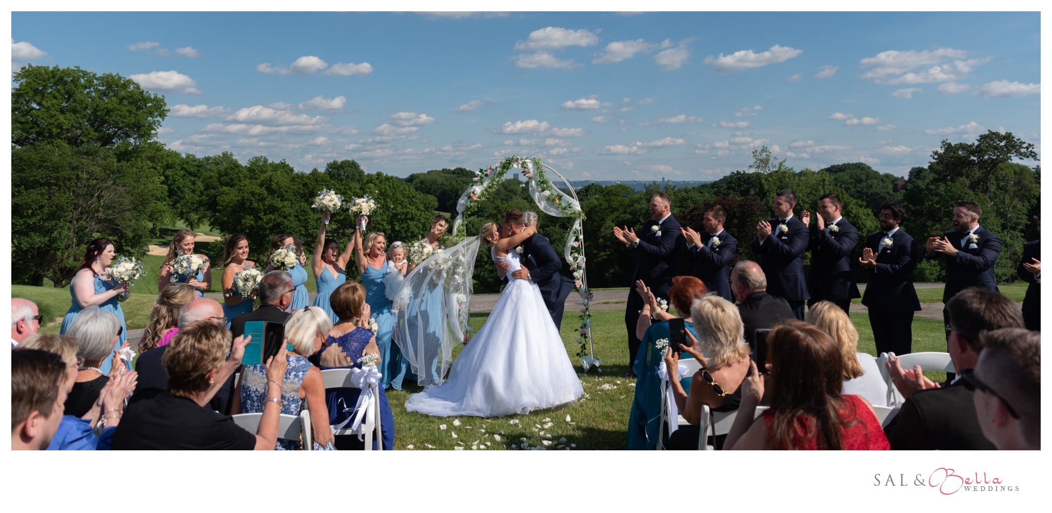 the couple seals their vows with a kiss on the golf course of Shannopin Country Club