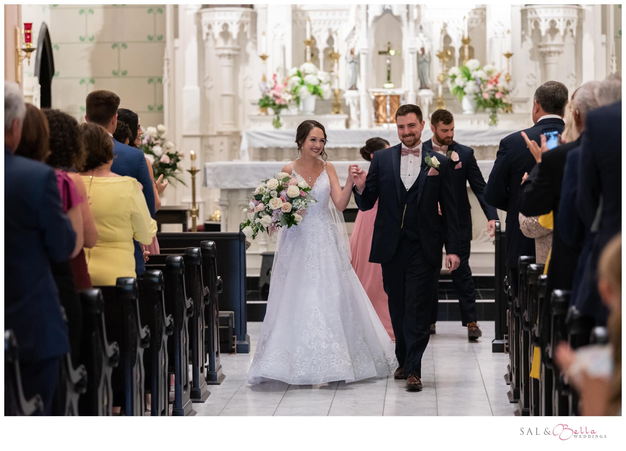 the newlyweds exit st. peter's catholic church in Pittsburgh for the first time as husband and wife.
