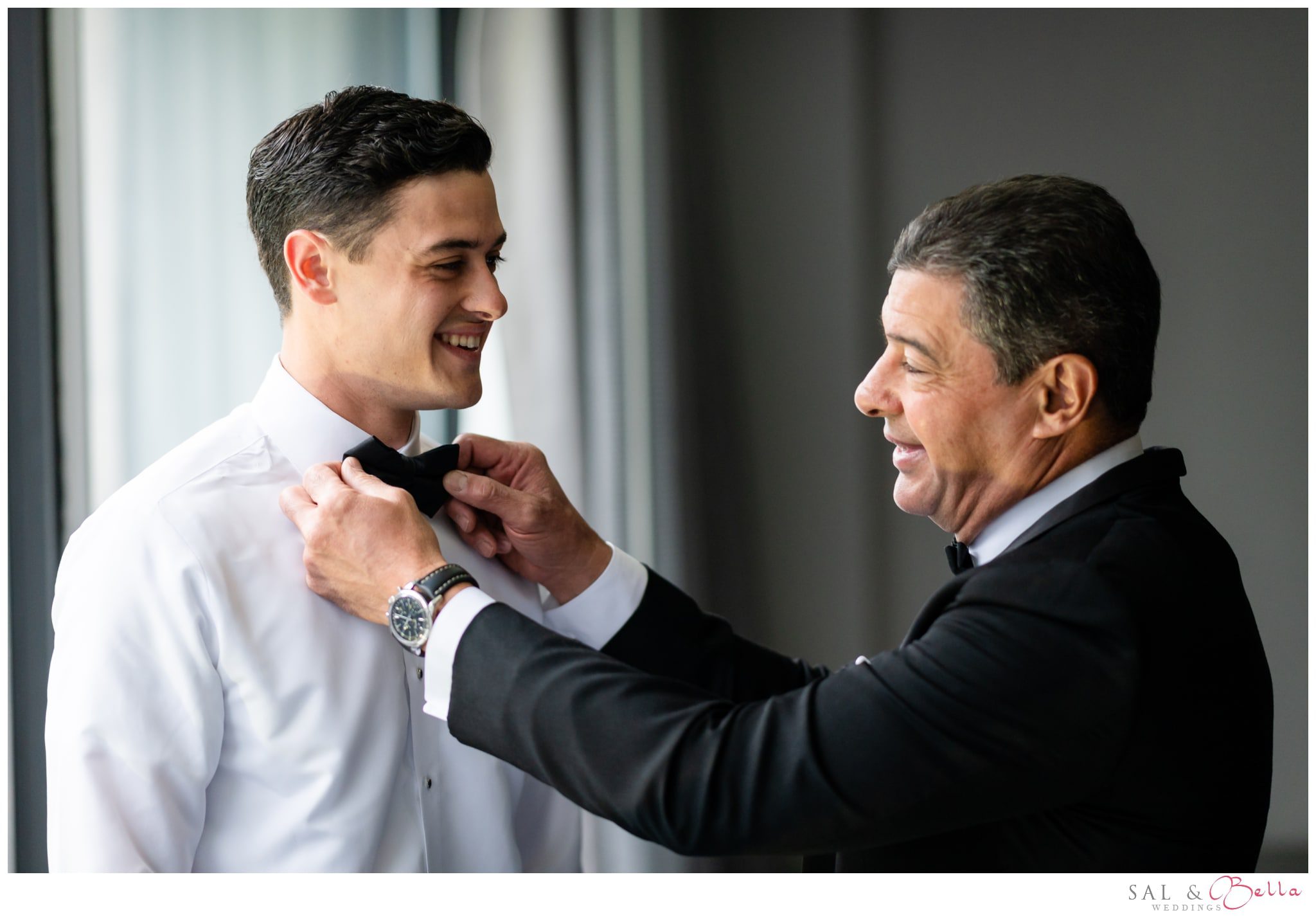 Groom's father adjusts his tie.