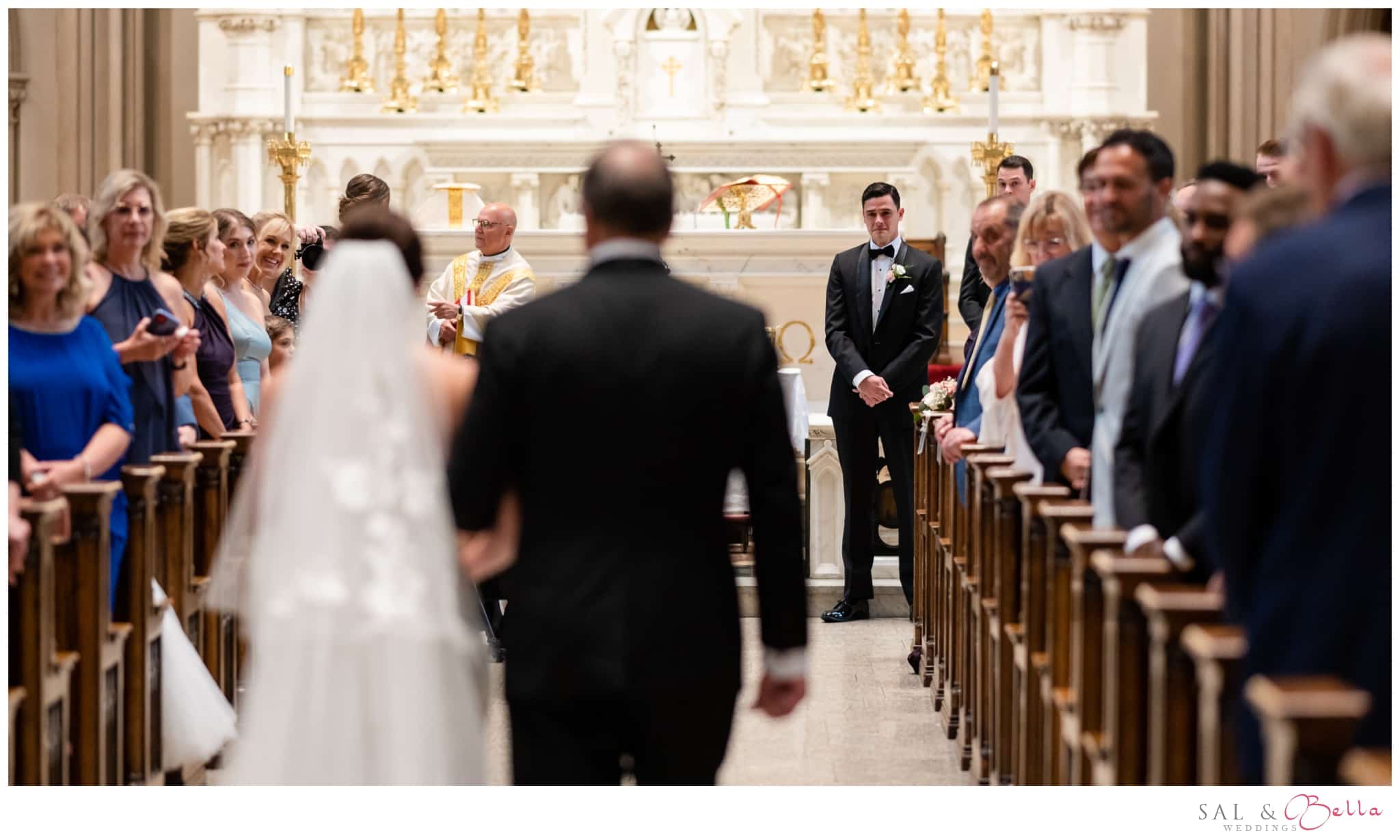 father walks his daughter down the aisle at St. Paul's Cathedral.