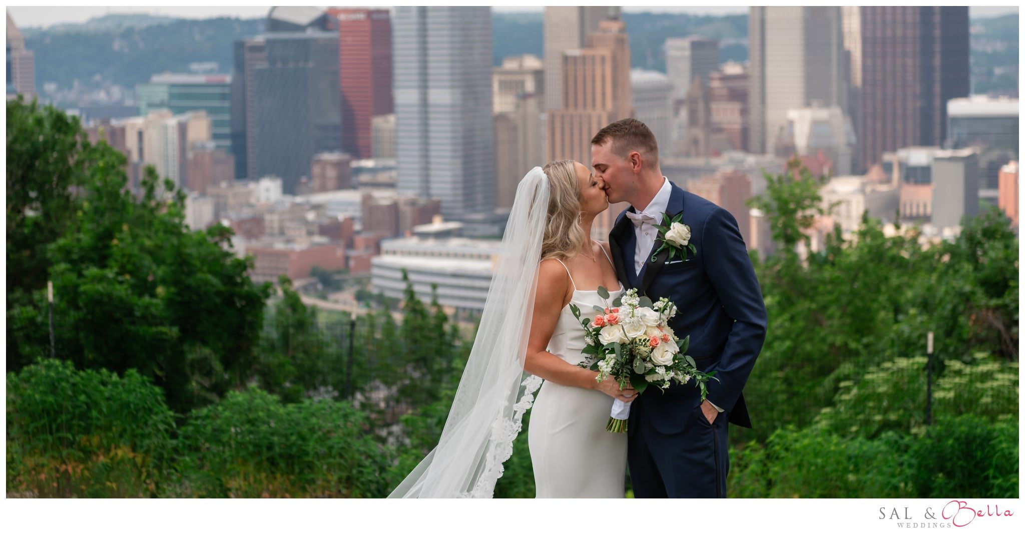 newlyweds kiss on mt washington in pittsburgh. 