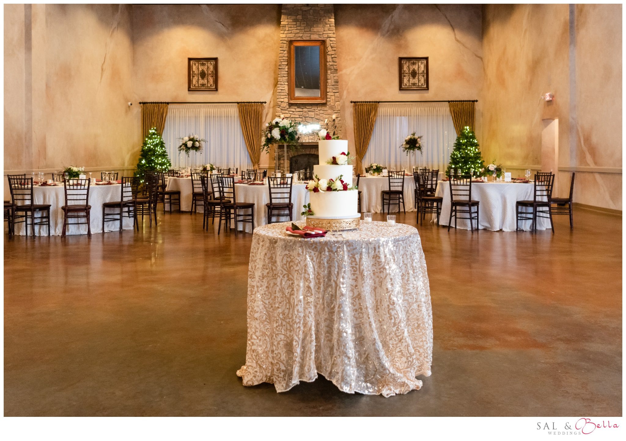 wedding cake decorates the middle of the ballroom at bella sera.