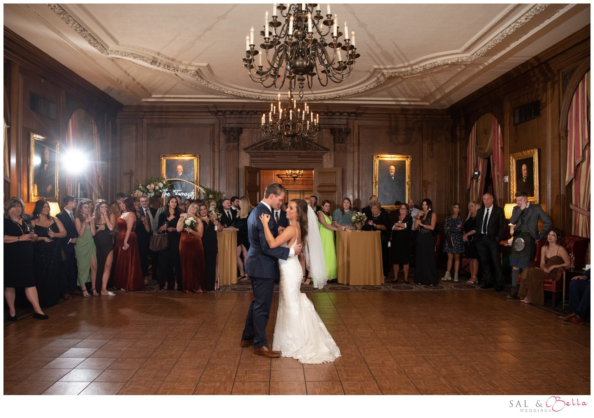 bride and groom share a first dance surrounded by loved ones the Duquesne Club in pittsburgh PA