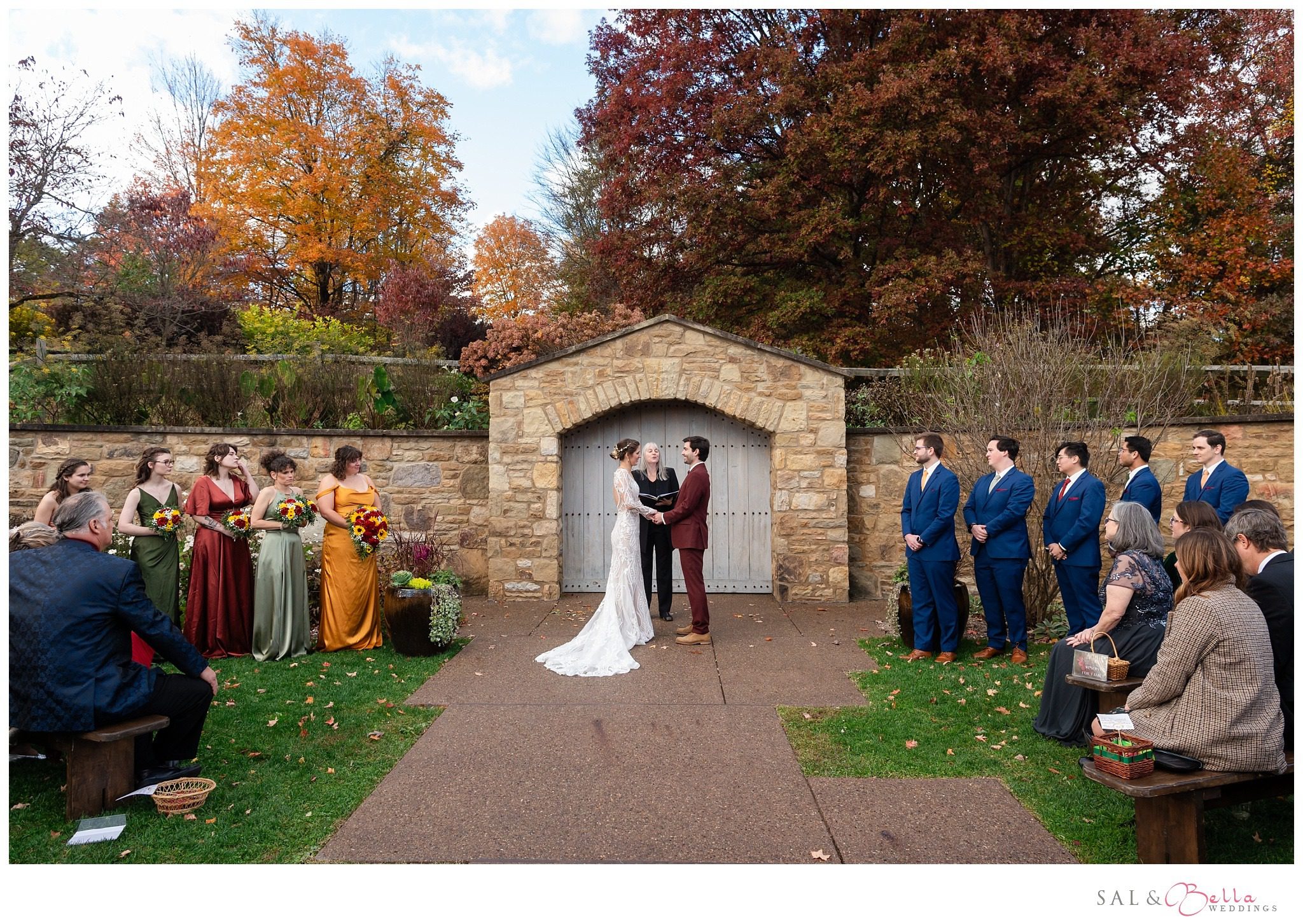 Bride and groom holding hands, with the Pittsburgh Botanic Garden ceremony space in full view.