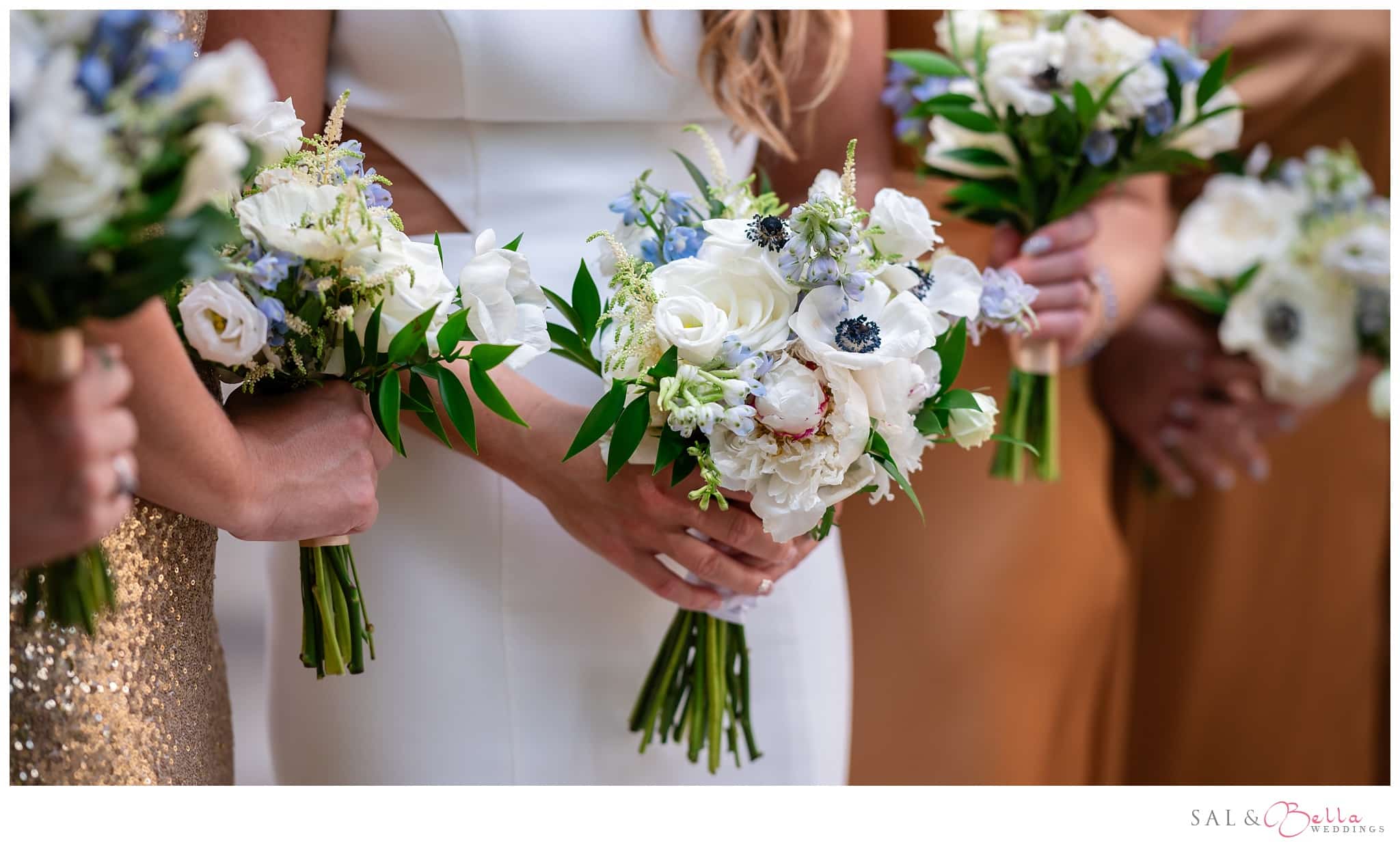 bridesmaids holding bouquets with a pitt university color scheme. 