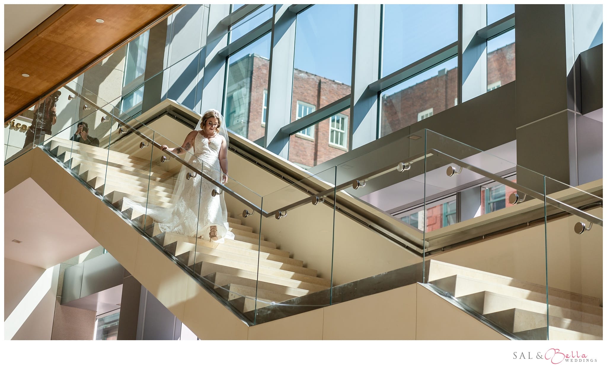 Bride walking down the grand staircase at the Fairmont hotel in Pittsburgh PA