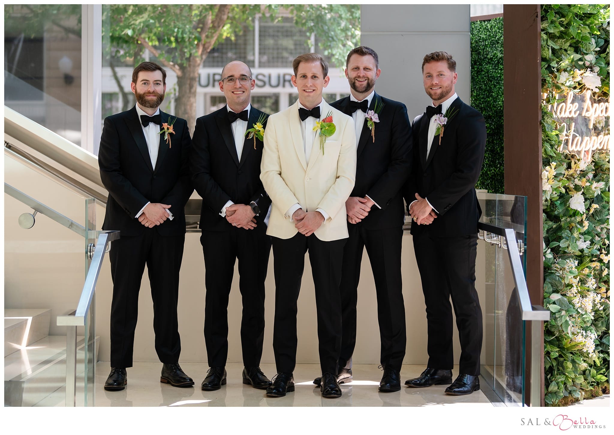 Groomsmen pose on the steps of the Fairmont Hotel for wedding photos.