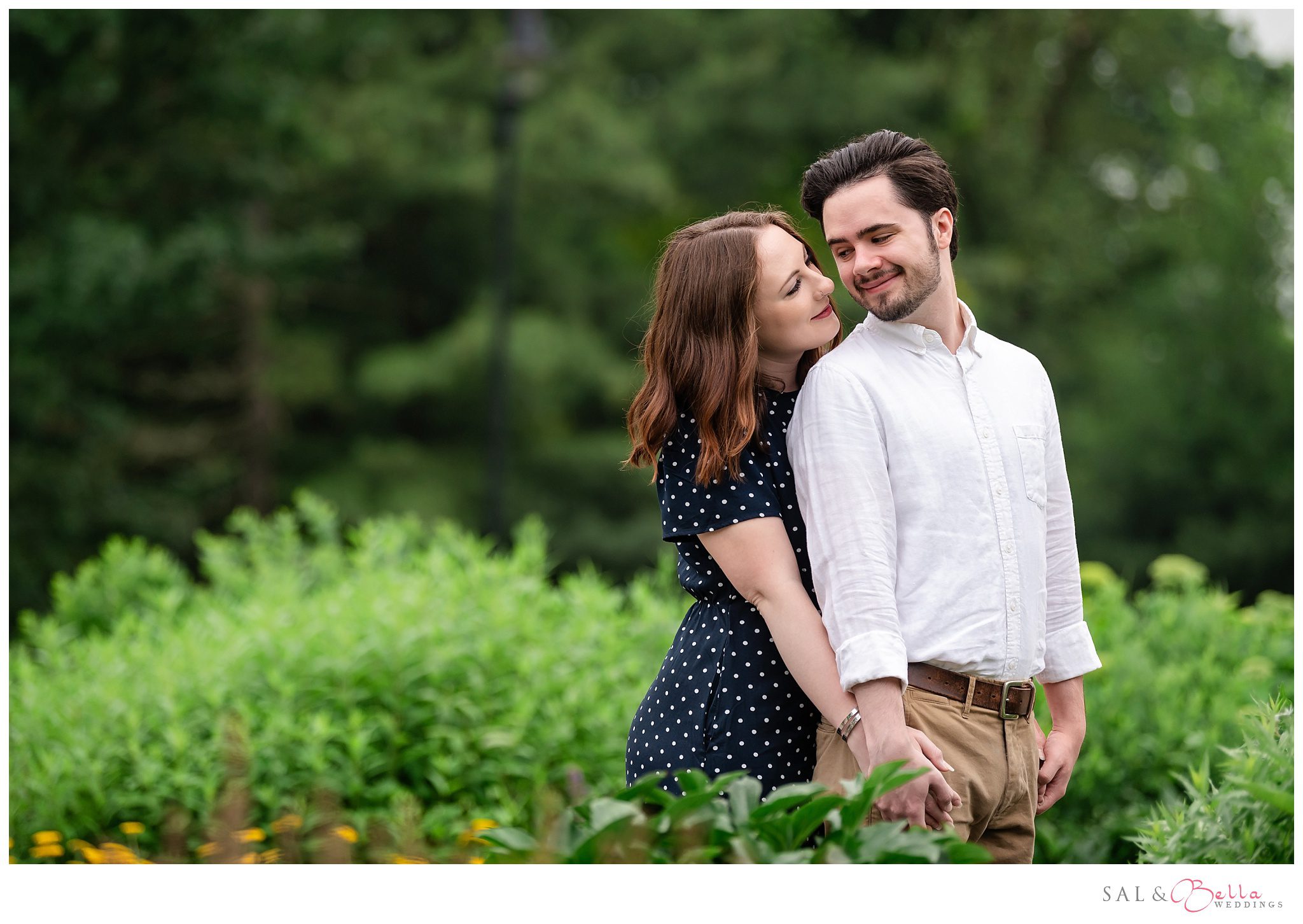 Engaged couple sharing a quiet moment by Carnegie Lake in Highland Park Pittsburgh.