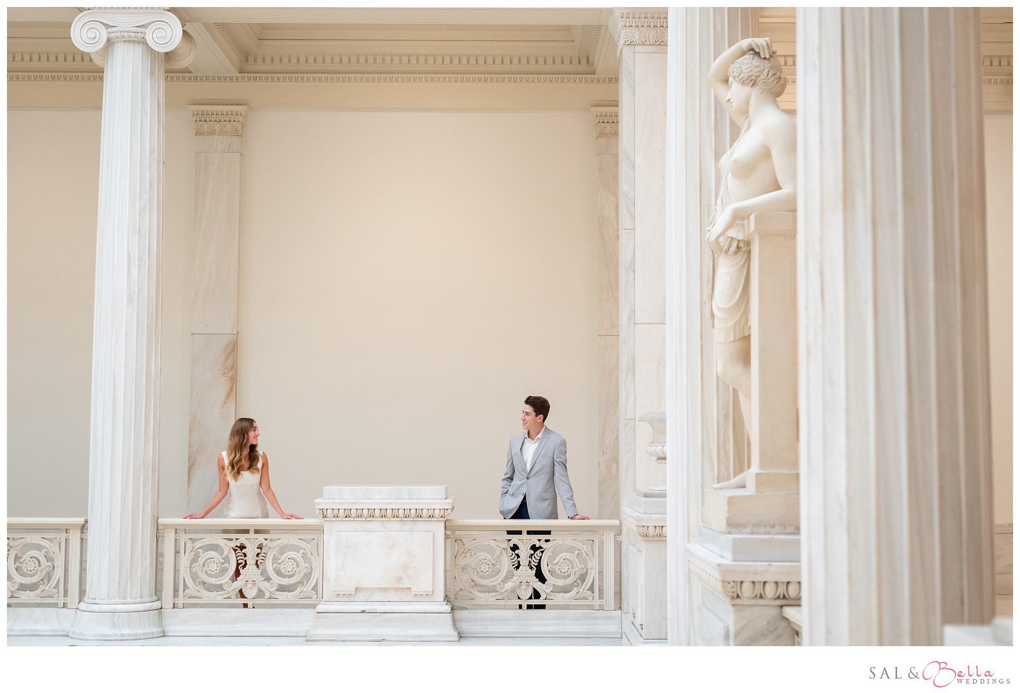 Wide-angle shot of engagement session in the Hall of Sculpture