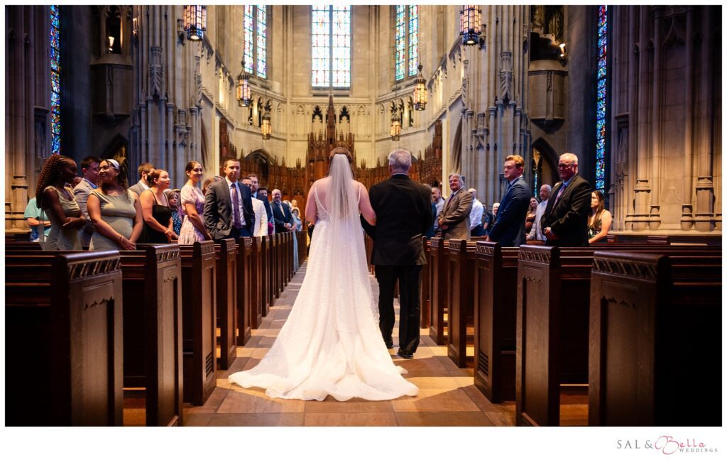Bride walking down the aisle with her grandfather during a traditional ceremony at Heinz Memorial Chapel in Pittsburgh