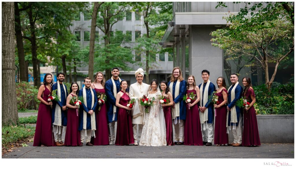 Bridal party poses as a group in the courtyard behind the wyndham. 