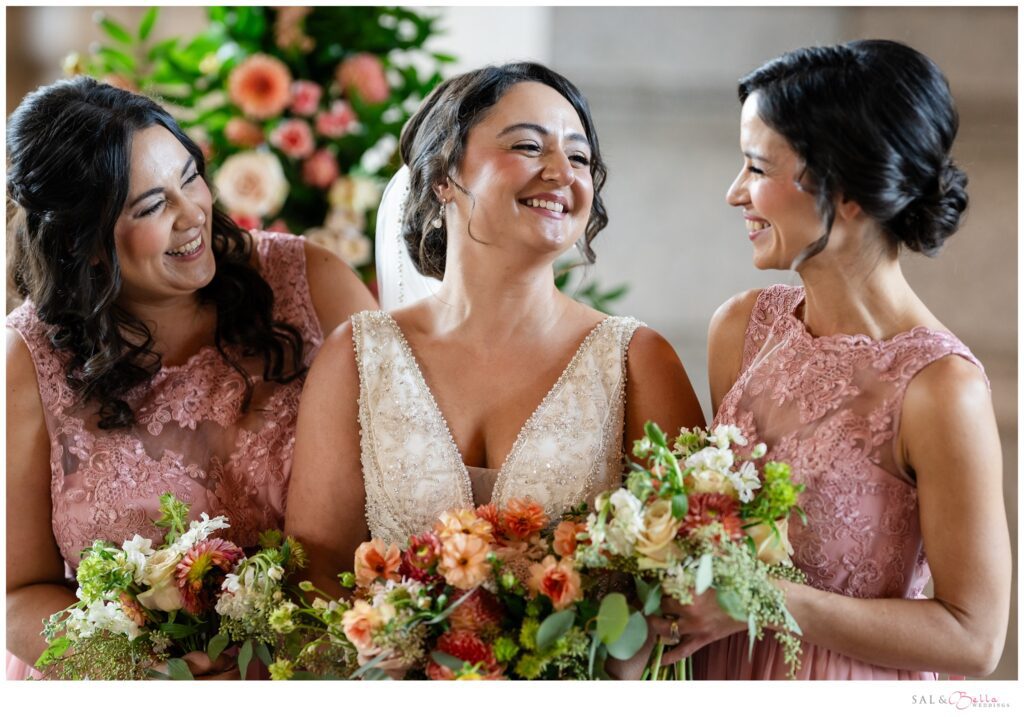 Bride laughs with her bridesmaids.
