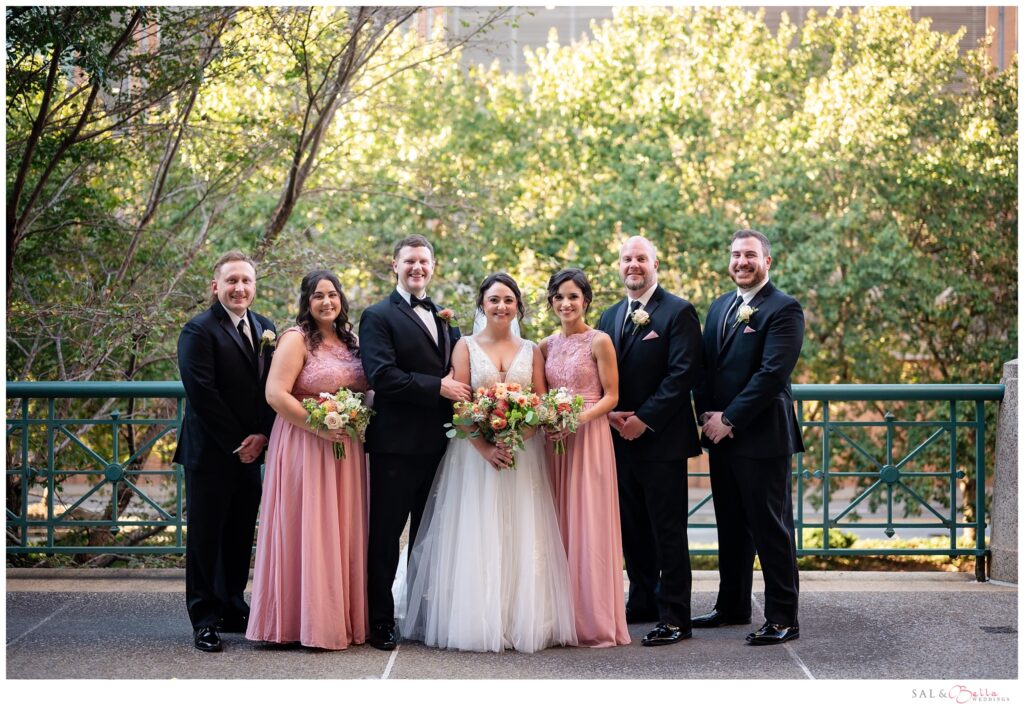 Bridal Party poses for portraits on the sidewalk at the Pennsylvanian. 