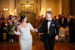 The newlyweds exude happiness as they are announced into their reception at the Priory in Pittsburgh.