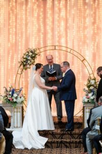 wedding ceremony taking place in the Grand Hall at the Priory.