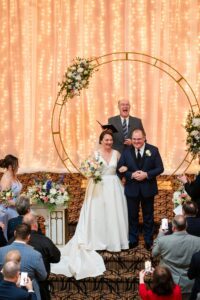 The officiant pronounces the couple Husband & Wife during their Priory wedding ceremony.