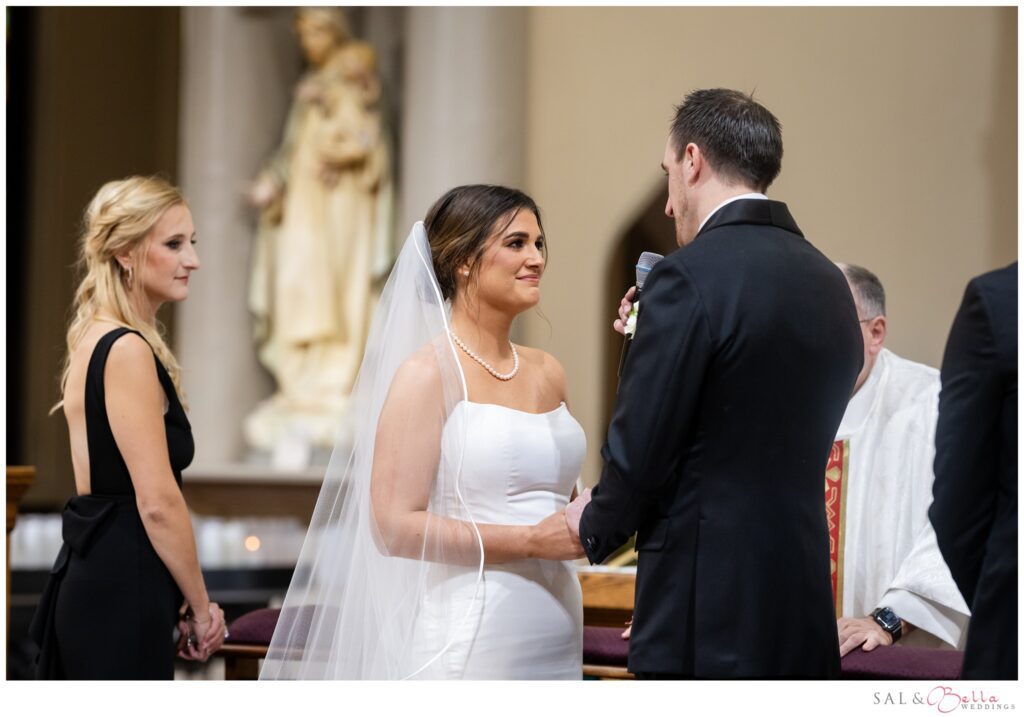 Elle and Mike hold hands and exchange vows during their St. Mary of the Mount wedding ceremony